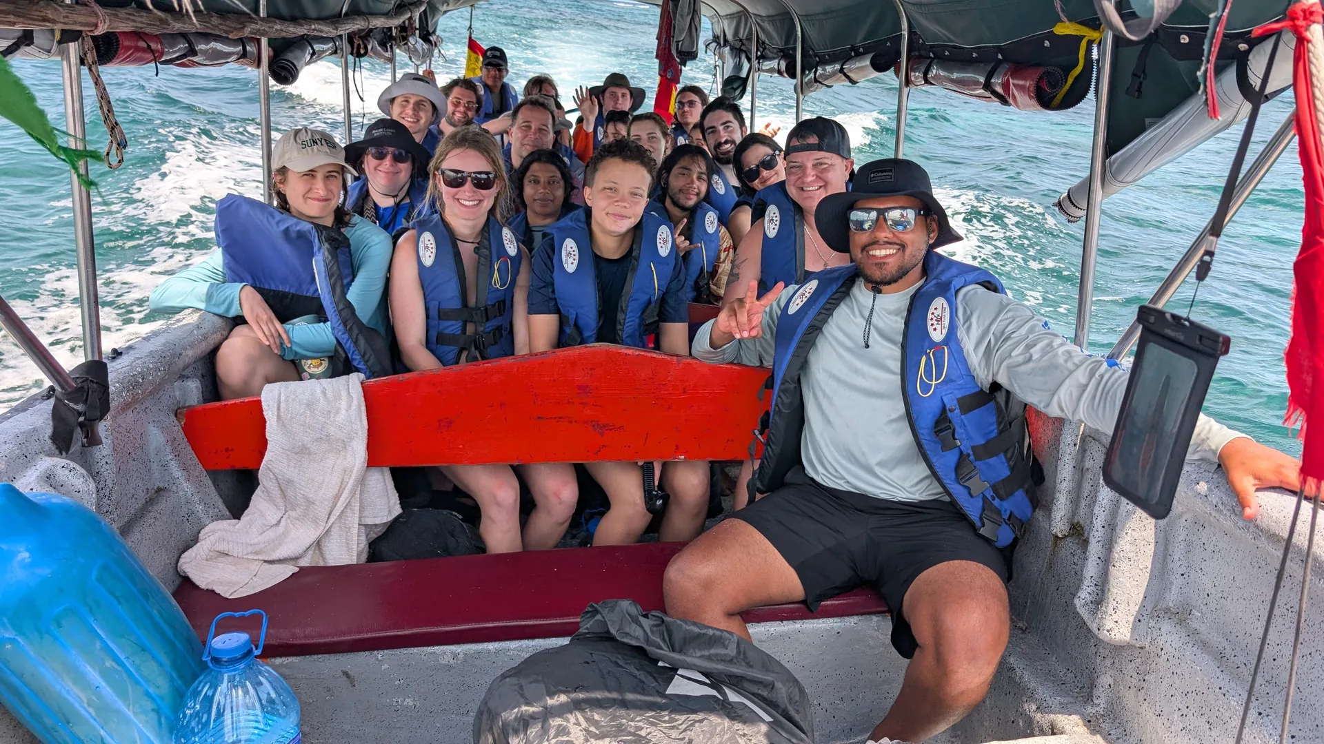 Visitors wearing life jackets aboard a covered passenger boat in the San Blas Islands.